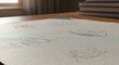 © Lone - Close-up of sketches on paper with books in the background.