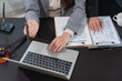 © Kritdanai - Legal Counsel Consultation: Hands on a laptop and documents with a gavel in the foreground symbolize legal discussion and consultation between professionals.