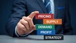 © nakamuto - Businessman stacking blocks with keywords about business strategy