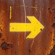 © Deddy - Yellow Arrow on Rusty Metal - Direction and Industrial Texture.