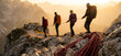 © xinxia - Four adult mountaineers traverse a rocky alpine trail at golden hour, connected by a safety rope, with coiled climbing gear resting on nearby rocks.