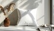 © Ardijojo - White pillow rests on a windowsill beside a decorative wooden vase filled with dried ornamental grasses, creating a minimalist and tranquil composition illuminated by natural sunlight and showcasing.