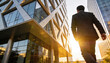 © PixelNexusArt - Businessman walking outside modern office building with sunlight shining for reentry and employment success