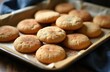 © miss irine - Freshly baked snickerdoodle cookies piled on a baking sheet. These warm, sweet, cinnamon sugar treats are ready to eat. Perfect for cafes, bakeries or holiday baking.