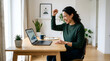 © BigaZoo - Happy woman celebrating success on laptop in home office