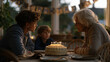 © forenna - Three generations gathered around a dining table for a grandmother's ninetieth birthday, handmade banner strung across the window, mismatched chairs pulled close, a tiered cake with candles glowing