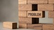 © Clark Still - Wooden blocks form a wall with one piece labeled problem above a gap on a plain background.