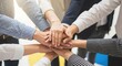 © TUFAELAHMED - Business people stacking hands in a symbol of unity and teamwork