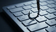 © Mirivox - A fishing hook hovers above a computer keyboard, symbolizing digital danger and cyber threat, representing vulnerability in the online world