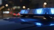 © ANDREY PROFOTO - Blue emergency light bar on police car at night in city