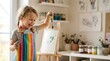 © Geramethone - Happy little girl splashing paint on canvas at home art studio