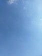 © CRYSTALCLOUD - Clear light blue sky background with minimal wispy clouds and empty copy space - vertical view.