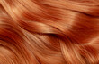 © Vera - Red hair close-up as a background. Women's long orange hair. Beautifully styled wavy shiny curls. Hair coloring bright shades. Hairdressing procedures, extension.