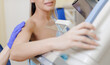 © Parilov - Woman receiving mammogram screening during clinic visit, white light