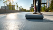 © AnastasiiaAkh - Construction worker applying protective floor coating with paint roller on modern residential terrace in sunny urban environment