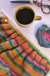 © MW Photography  - hand knitting making a sweater from self striping alpaca wool on table with cup of coffee and scissors