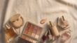 © Digital Arts Pro - Luxury Cosmetics Flat Lay Background: A premium graphic resource of makeup products on beige fabric with copy space for beauty branding design.