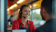 © Viktor - Smiling female fast food worker wearing headset takes order from customer at drive-thru window. Friendly service interaction at modern restaurant.