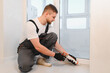 © Serhii - Worker applying caulk sealant during window renovation process