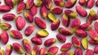 © Adrian - Vividly colored shelled nuts are scattered across a clean light surface.