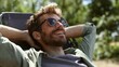 © ASDF - A man is relaxing in a chair with his arms around his neck