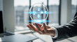 © imagemir - A businessman in a suit holds a translucent sphere displaying digital icons in an illuminated office setting.