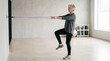 © Cliff - Active senior elderly woman doing fitness exercises during workout, minimalist concept for healthy lifestyle, aging and wellness