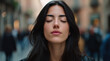 © Keopaserth - Woman portrait closed eye meditation calm face dark hair urban background blurred crowd peaceful mood natural light young adult
