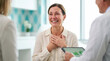 © Len_mik - Happy patient receiving good news from medical professionals in bright consultation office for healthcare websites, emotional wellness blogs, and patient support materials