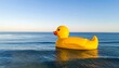 © Linastudio - Giant Yellow Rubber Duck Floats Peacefully in the Vast Ocean Under a Clear Blue Sky
