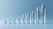 © mostafizur - Clear glass bar graph showing upward trend on light blue background.