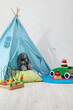 © New Africa - Wigwam, toys and pillows near white wall in child's room, closeup