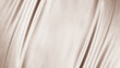 © Наталья Босяк - Light brown beige textile fabric. Elegant luxury background. Soft folds, curved lines. Nude pastel. Beauty branding fashion wedding. Premium cosmetic design. Empty template. Flat lay, table top view.