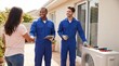 © SimpleDesignStudio - Female Homeowner Shaking Hands with HVAC Technician After Successful Air Conditioning Repair Service