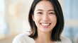 © Ura - Smiling Asian Woman Portrait with Soft Natural Light Background