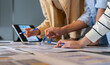 © Art_Photo - Close up of business consultant team hands pointing at data summary charts with pens on table, Corporate data analysts discussing financial strategy, market research and investment planning concept