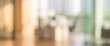 © al-sultan - A blurred interior of a modern office space with sunlight streaming through large windows, showcasing a warm and inviting atmosphere.