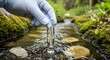 © MD HASANUZZAMAN - Scientist Collecting Water Sample from Forest Stream for Analysis