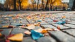 © AmyPhotography - Autumn leaves and colorful event debris scattered across a city square pavement
