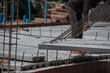 © saksuvan - Crane loader for lifting bundles of precast concrete slabs.
