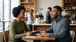 © Николай Срибяник - African American man and woman talking over coffee in a modern cafe.