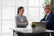 © David - Businesswoman crossing arms, upset and stressed during a tense office disagreement with a male colleague or boss, showing workplace conflict and difficult professional interaction