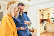 © baranq - Couple looking at tablet together and planning at home