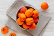 © Liudmyla - Raw Organic Apricots in a Bowl, top view. Flat lay, overhead, from above.