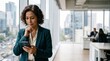 © Eve - Thoughtful mature hispanic business woman manager looking at smartphone in modern office. Serious female corporate executive checking phone near panoramic window.