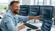 © pattozher - Software Developer at Work: A smiling male software developer with a beard sits at a desk, pointing at a computer monitor displaying lines of code.