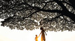 © ArtMind Rakib - Heartwarming family moment under tree at sunset, mother and child holding hands in warm light