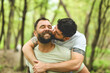 © Louis-Paul Photo - A Portrait of a happy gay couple outdoors in forest background