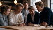 © forenna - Early-stage startup team of five clustered around prototype hardware on workshop bench, warm overhead bulb light, engineers and business leads debating manufacturing cost versus margin scaling path