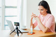 © Oleg Gekman - Young woman working with laptop computer in home kitchen. Work at home. Freelance, remote work. Woman advertises cosmetic products online